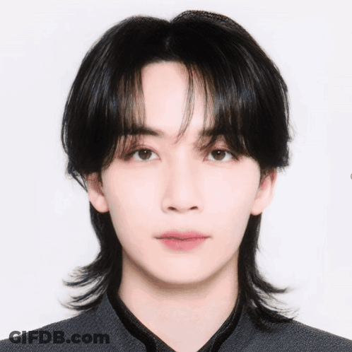 A Close Up Of A Young Man 'S Face With A Ponytail GIF