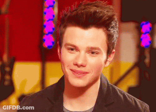A Close Up Of A Young Man 'S Face With A Purple Light Behind Him GIF