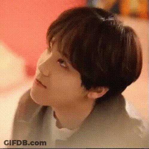 A Close Up Of A Young Man 'S Face With A Red Background . GIF