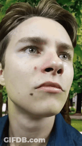 A Close Up Of A Young Man 'S Face With A Red Spot On His Nose GIF
