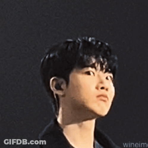 A Close Up Of A Young Man 'S Face With A Serious Expression . GIF