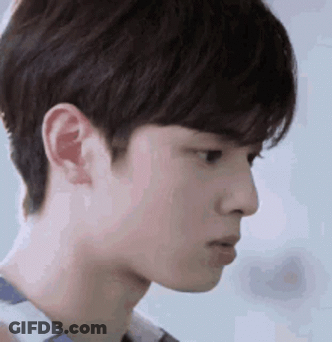 A Close Up Of A Young Man 'S Face With A Serious Expression On His Face . GIF