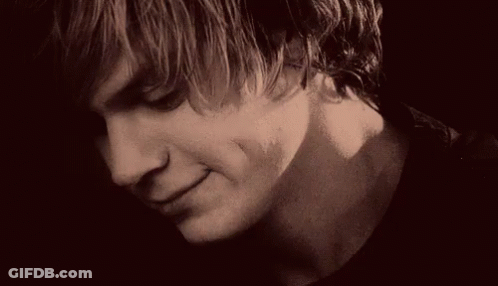 A Close Up Of A Young Man 'S Face With A Serious Look On His Face In A Black And White Photo . GIF
