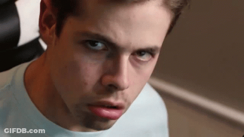 A Close Up Of A Young Man 'S Face With A Serious Look On His Face GIF