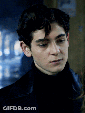 A Close Up Of A Young Man 'S Face With A Sign In The Background That Says No Smoking GIF