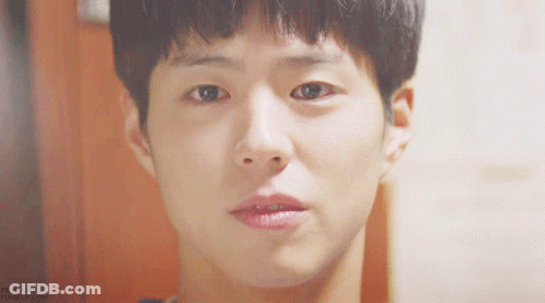A Close Up Of A Young Man 'S Face With A Slight Smile On His Face GIF