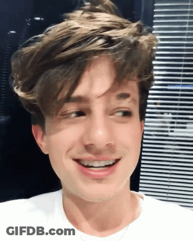 A Close Up Of A Young Man 'S Face With A Smile GIF