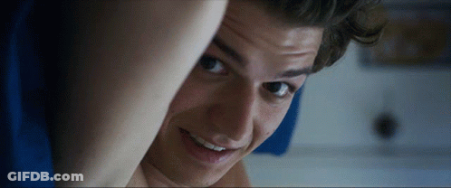 A Close Up Of A Young Man 'S Face With A Smile On His Face GIF