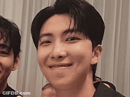 A Close Up Of A Young Man 'S Face With A Smile On His Face . GIF