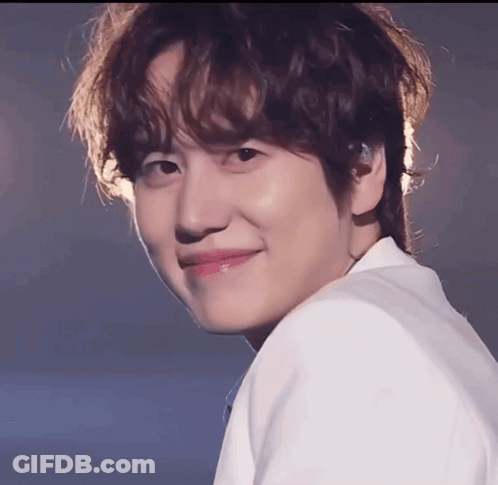 A Close Up Of A Young Man 'S Face With A Smile On His Face GIF