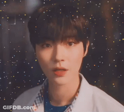 A Close Up Of A Young Man 'S Face With A Starry Background GIF