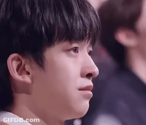 A Close Up Of A Young Man 'S Face With A Tear Running Down His Cheek . GIF