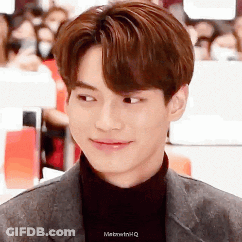 A Close Up Of A Young Man 'S Face With A Turtleneck And A Suit . GIF