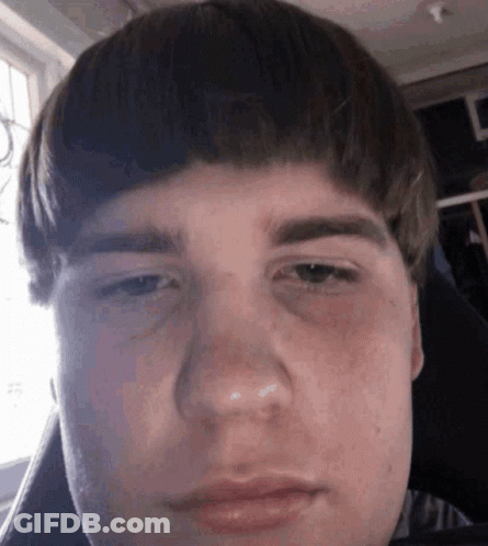 A Close Up Of A Young Man 'S Face With A Very Serious Look On His Face . GIF