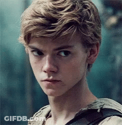 A Close Up Of A Young Man 'S Face With Blonde Hair And A Backpack . GIF
