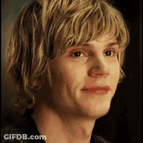 A Close Up Of A Young Man 'S Face With Blonde Hair And A Black Shirt . GIF
