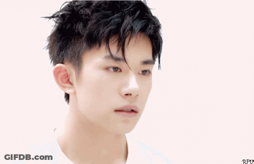 A Close Up Of A Young Man 'S Face With Chinese Writing Below Him GIF