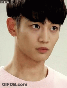 A Close Up Of A Young Man 'S Face With Chinese Writing On The Bottom GIF