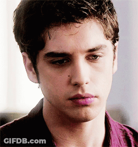 A Close Up Of A Young Man 'S Face With His Eyes Closed GIF