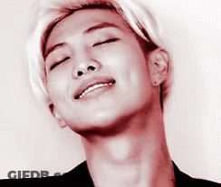 A Close Up Of A Young Man 'S Face With His Eyes Closed And A Smile On His Face . GIF
