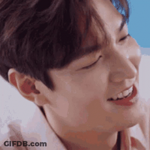 A Close Up Of A Young Man 'S Face With His Eyes Closed And His Mouth Open . GIF