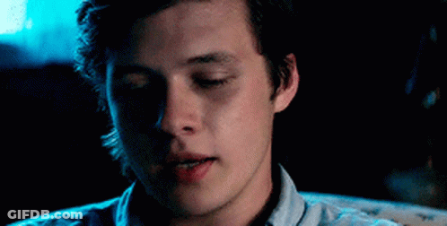 A Close Up Of A Young Man 'S Face With His Eyes Closed In A Dark Room . GIF