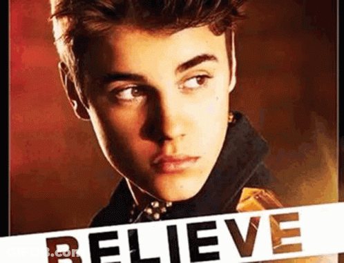 A Close Up Of A Young Man 'S Face With The Word Believe Written On It . GIF