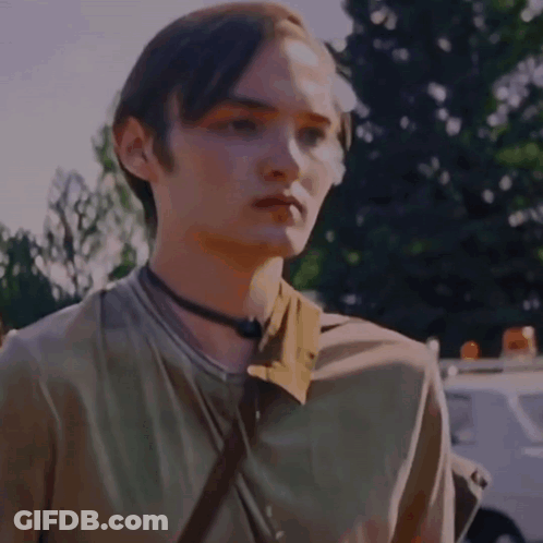 A Close Up Of A Young Man 'S Face With Trees In The Background GIF