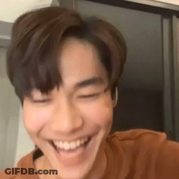 A Close Up Of A Young Man Smiling With His Eyes Closed And His Mouth Open . GIF