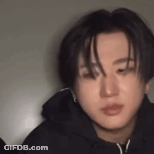 A Close Up Of A Young Man Wearing A Black Hoodie And Earrings . GIF