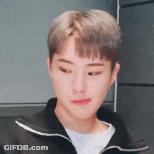 A Close Up Of A Young Man Wearing A Black Jacket And A White Shirt Making A Funny Face . GIF