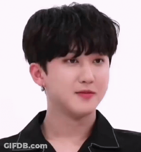 A Close Up Of A Young Man Wearing A Black Shirt And Earring . GIF