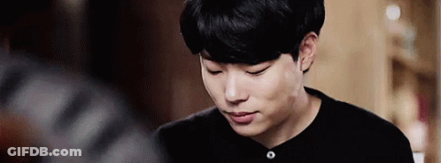 A Close Up Of A Young Man Wearing A Black Shirt Looking Down . GIF