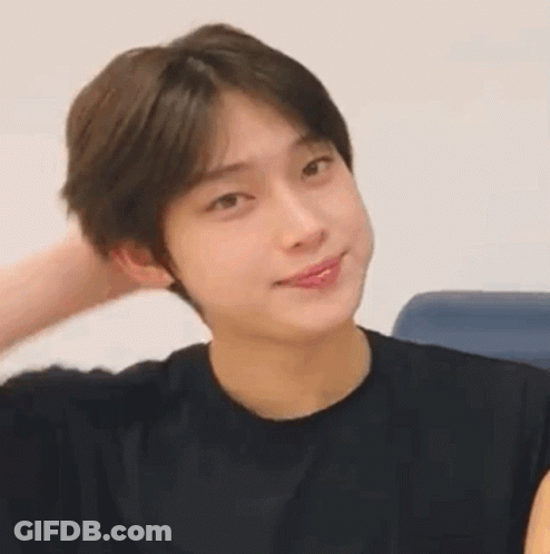 A Close Up Of A Young Man Wearing A Black Shirt Making A Funny Face . GIF