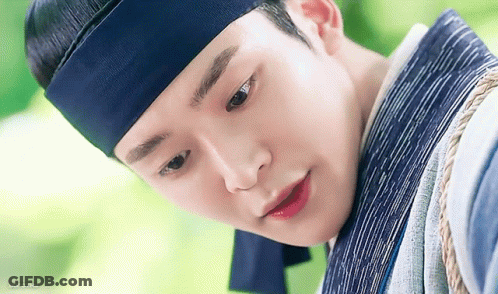 A Close Up Of A Young Man Wearing A Blue Headband And A Blue Scarf . GIF