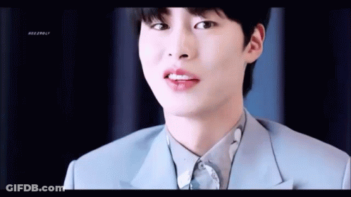 A Close Up Of A Young Man Wearing A Blue Suit And White Shirt . GIF