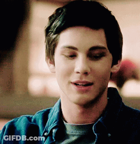 A Close Up Of A Young Man Wearing A Denim Shirt GIF