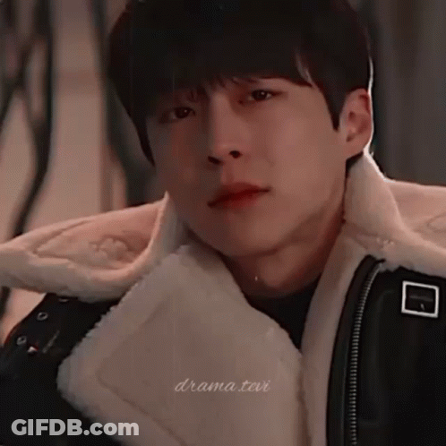 A Close Up Of A Young Man Wearing A Fur Coat GIF