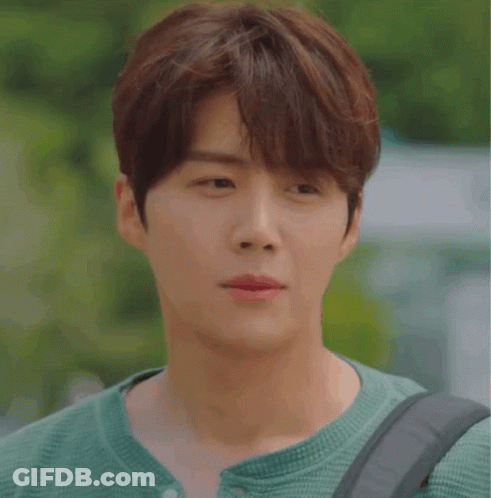A Close Up Of A Young Man Wearing A Green Shirt GIF