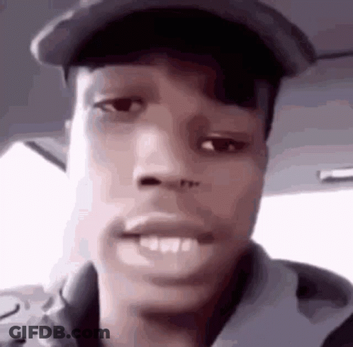 A Close Up Of A Young Man Wearing A Hat And A Hoodie . GIF