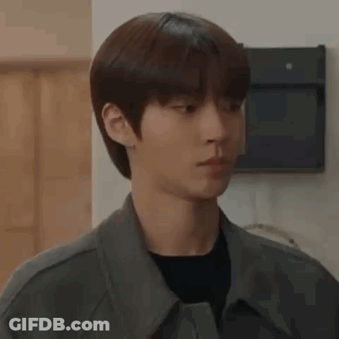 A Close Up Of A Young Man Wearing A Jacket And A Black Shirt Looking At The Camera . GIF