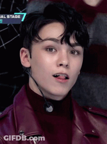 A Close Up Of A Young Man Wearing A Leather Jacket And A Microphone With The Number 7 On It GIF