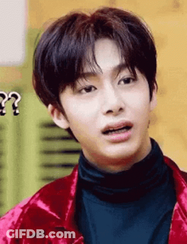 A Close Up Of A Young Man Wearing A Red Jacket And Black Turtleneck . GIF