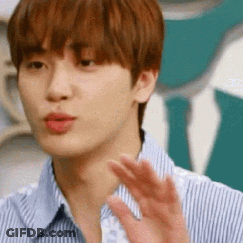 A Close Up Of A Young Man Wearing A Striped Shirt And Tie Waving His Hand . GIF
