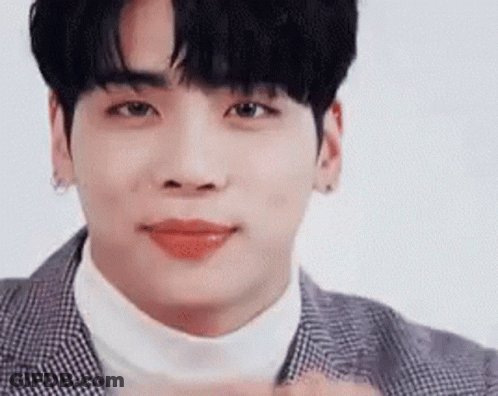 A Close Up Of A Young Man Wearing A Suit And Turtleneck Sweater . GIF