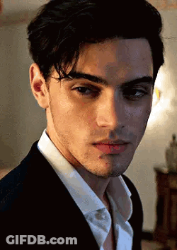 A Close Up Of A Young Man Wearing A Suit And White Shirt . GIF