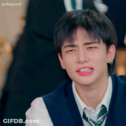 A Close Up Of A Young Man Wearing A Vest And Tie Making A Funny Face . GIF