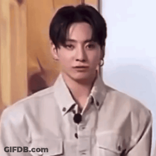 A Close Up Of A Young Man Wearing A White Shirt And A Microphone . GIF