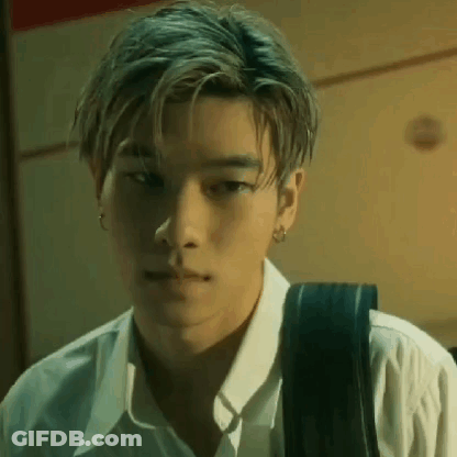 A Close Up Of A Young Man Wearing A White Shirt And Carrying A Backpack . GIF