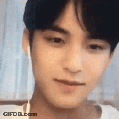 A Close Up Of A Young Man Wearing Ear Buds . GIF